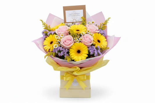 Compact Mother's Day bouquet with pink roses and yellow gerbera in cream gift box with branded card